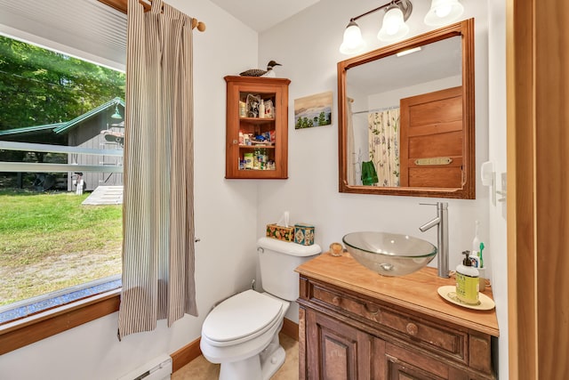 full bath with baseboards, toilet, baseboard heating, and vanity