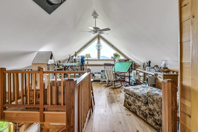 additional living space with light wood-type flooring, vaulted ceiling, and ceiling fan