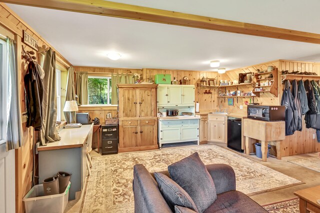 interior space featuring black appliances, wood walls, and beam ceiling