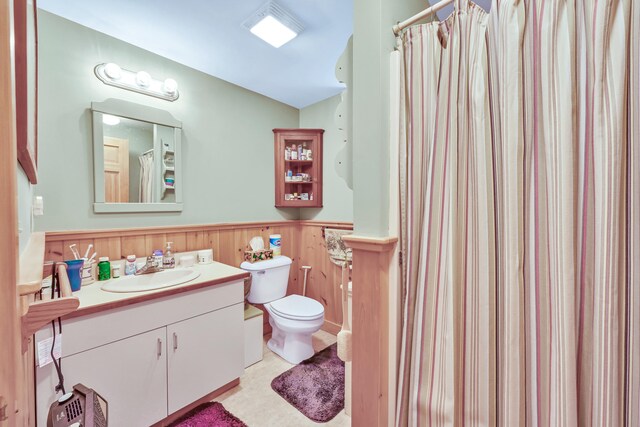 bathroom with toilet, tile patterned flooring, vanity, wood walls, and a shower with curtain