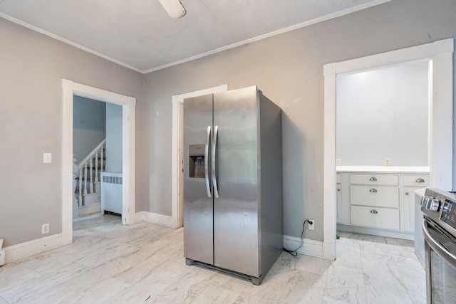 kitchen featuring ornamental molding, radiator heating unit, stainless steel appliances, and white cabinets