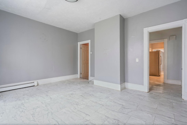 unfurnished bedroom featuring a textured ceiling, baseboard heating, and stainless steel fridge