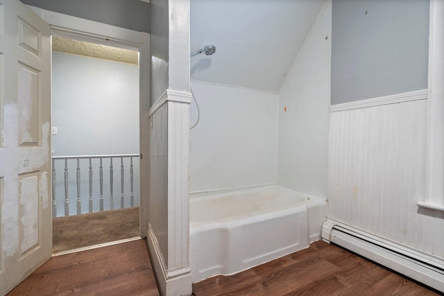 bathroom featuring wood-type flooring, a baseboard radiator, vaulted ceiling, and a bath