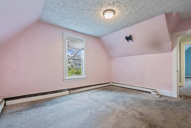 additional living space featuring carpet floors, a textured ceiling, baseboard heating, and vaulted ceiling