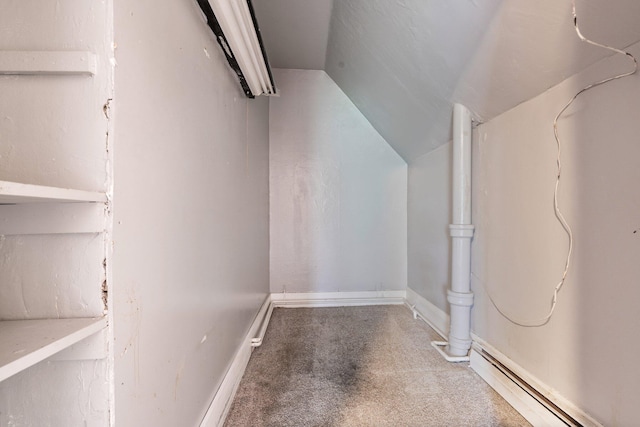 interior space with carpet, lofted ceiling, and a baseboard radiator