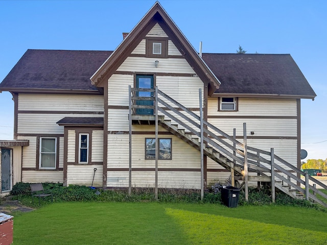 back of house featuring a yard