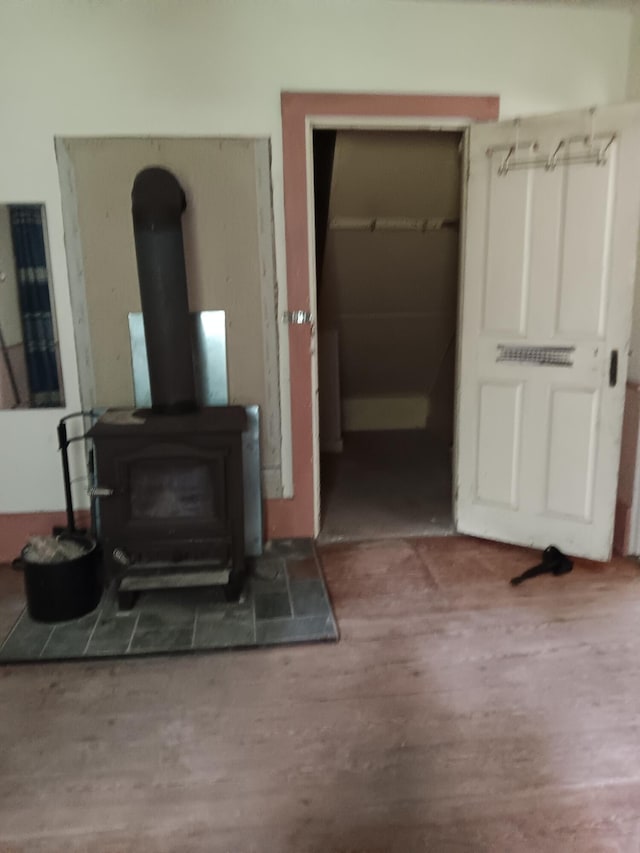 living room featuring wood finished floors and a wood stove