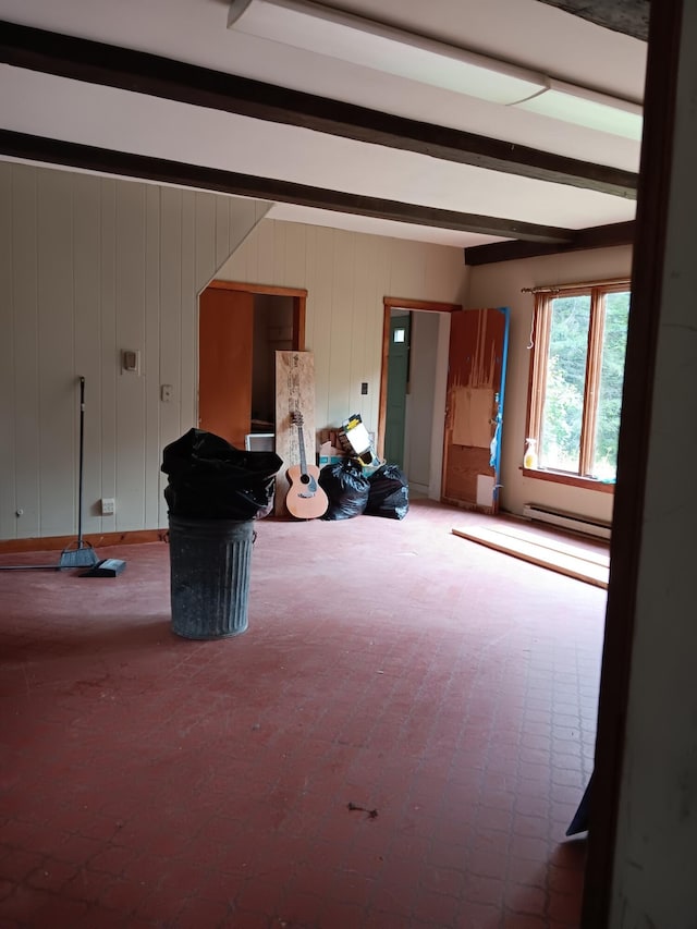 interior space with a baseboard radiator and beam ceiling