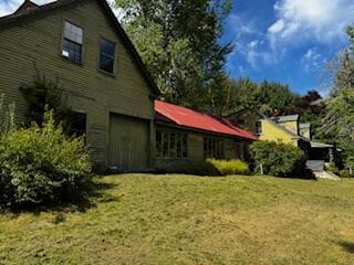 view of property exterior with a yard