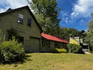 view of home's exterior with a lawn