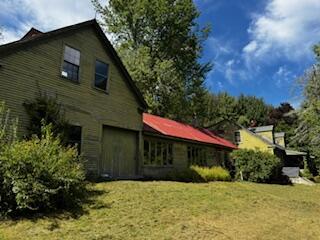 view of side of home featuring a yard