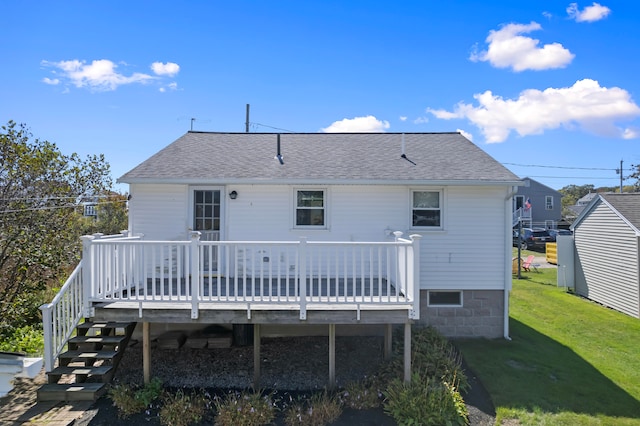 rear view of property with a wooden deck and a yard