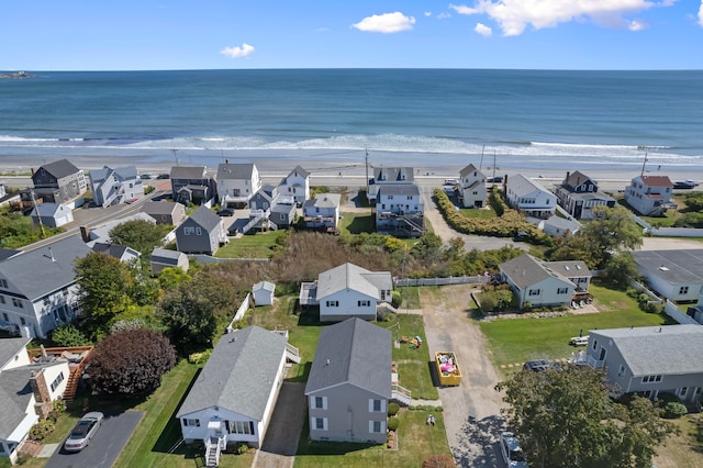 birds eye view of property featuring a water view and a view of the beach