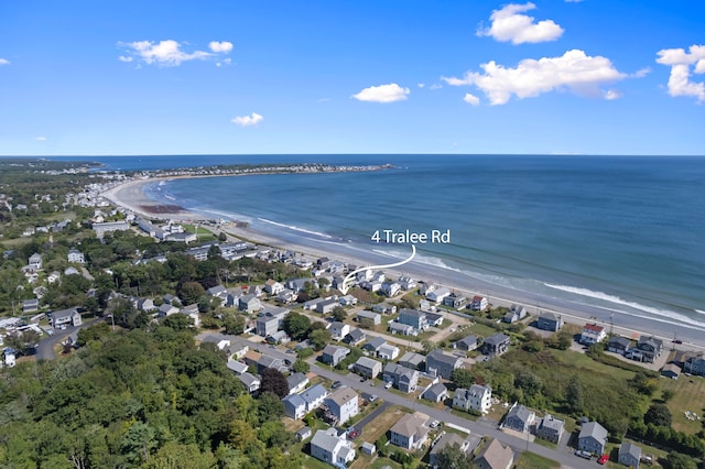 birds eye view of property with a water view and a beach view