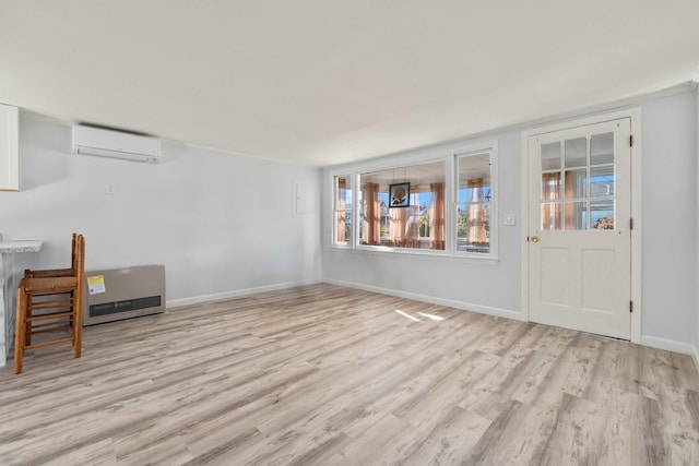 interior space featuring light hardwood / wood-style flooring and an AC wall unit