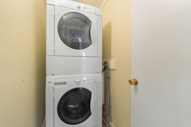 laundry area featuring stacked washer / drying machine