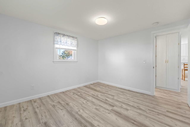 unfurnished room with light wood-type flooring