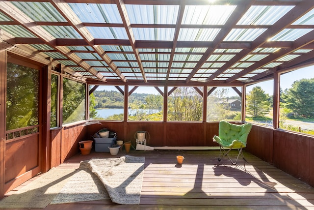 sunroom / solarium featuring a water view