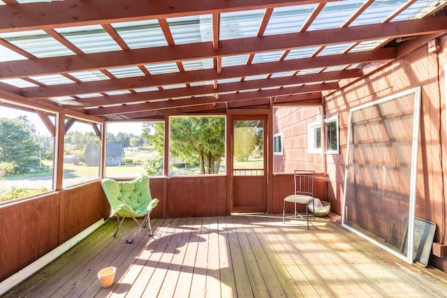 unfurnished sunroom featuring lofted ceiling