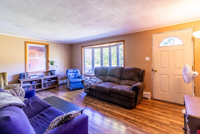 living room featuring a baseboard heating unit, crown molding, a textured ceiling, and wood-type flooring