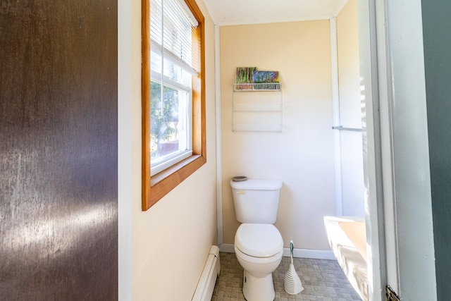 bathroom with baseboard heating, toilet, a bathing tub, and tile patterned floors