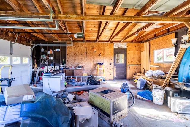 garage with wood walls and a garage door opener