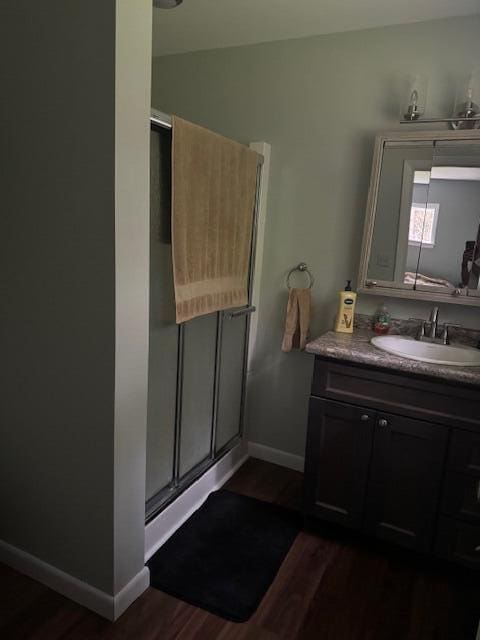 87 N Rd, Detroit, ME 04929 - full bath featuring wood finished floors, a shower stall, vanity, and baseboards