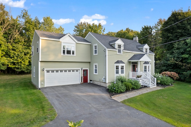 view of front of property featuring a garage and a front lawn