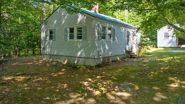 view of side of property featuring a shed