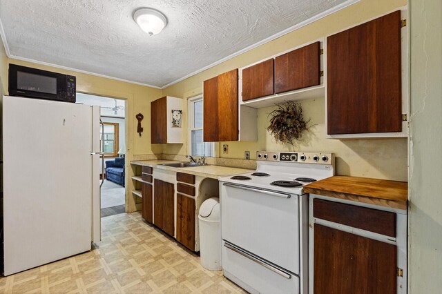 kitchen with ornamental molding, a textured ceiling, sink, and white appliances