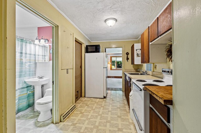 kitchen with ornamental molding, a textured ceiling, sink, and white appliances