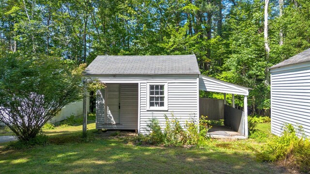 view of outbuilding featuring a lawn