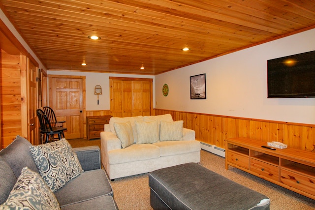 living room with ornamental molding, wood walls, a baseboard heating unit, wood ceiling, and carpet floors