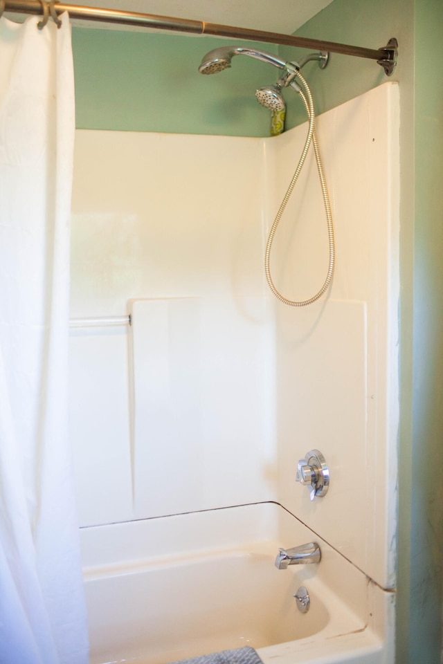 bathroom with shower / bath combo with shower curtain