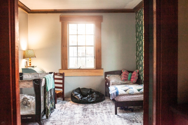 sitting room with ornamental molding and carpet floors