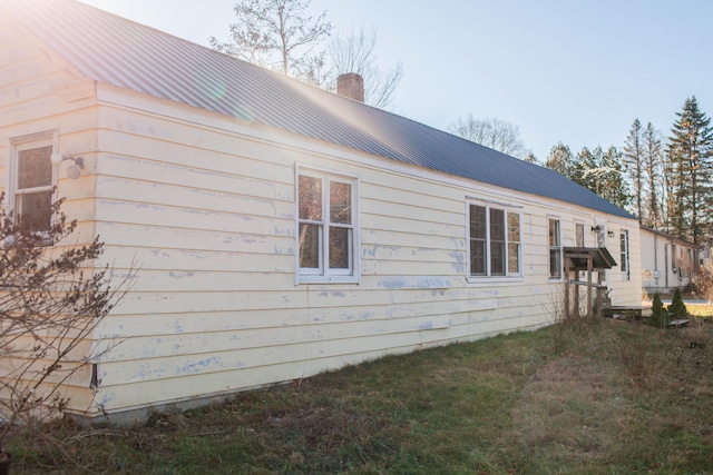 view of side of property with a yard