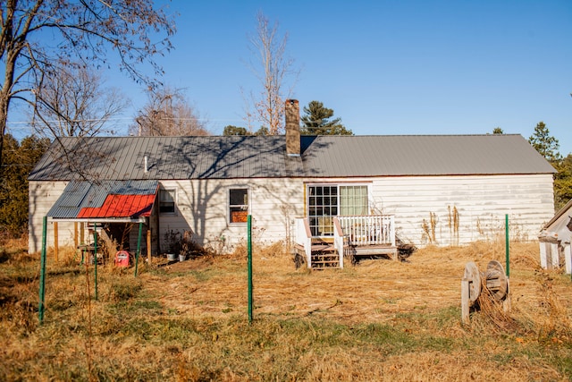 back of property featuring a deck