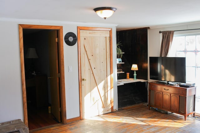 interior space with crown molding and light wood-type flooring