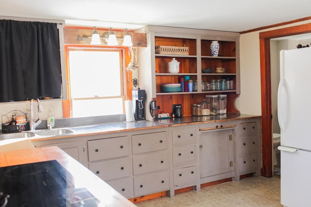 kitchen with sink and white fridge