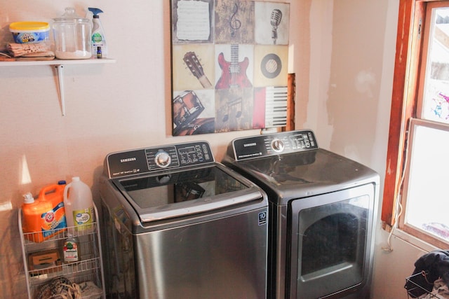 clothes washing area featuring washer and clothes dryer