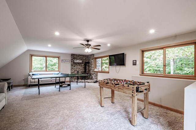 playroom with vaulted ceiling, ceiling fan, carpet floors, and a fireplace