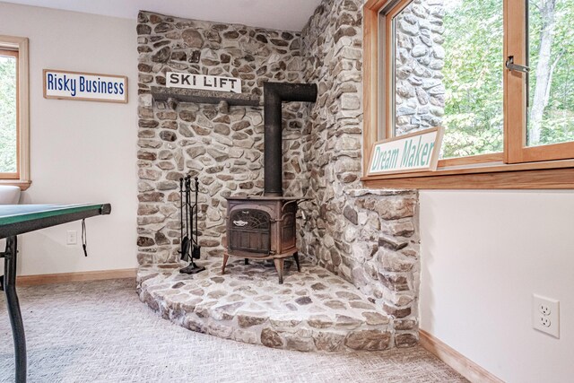 details with carpet and a wood stove