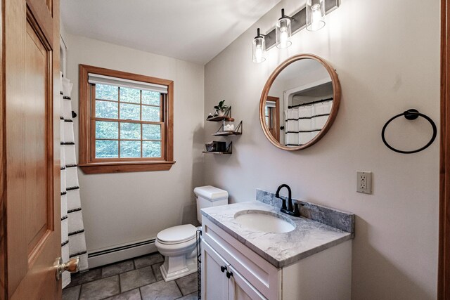 bathroom with baseboard heating, vanity, and toilet