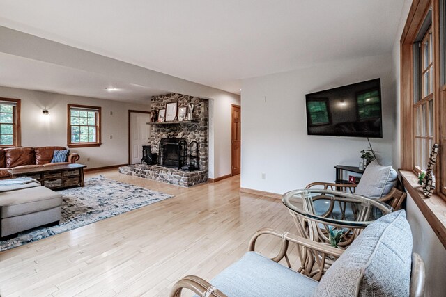 living room with light hardwood / wood-style floors and a fireplace