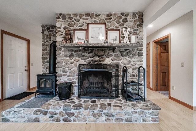 living room featuring a wood stove and light hardwood / wood-style floors