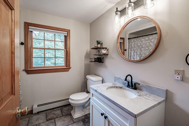 bathroom with toilet, vanity, and baseboard heating