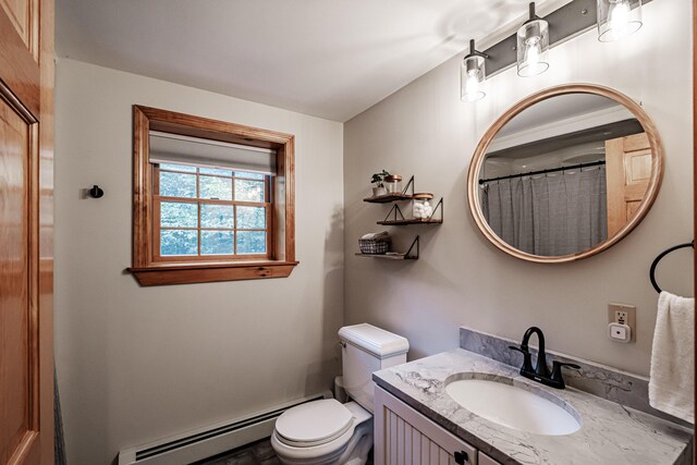 bathroom with vanity, toilet, and a baseboard heating unit