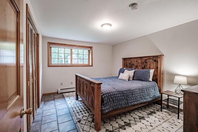 bedroom featuring a baseboard radiator and a closet