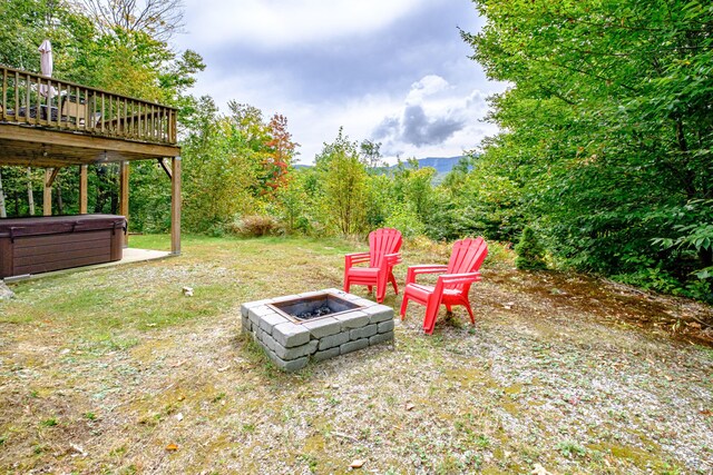 view of yard featuring a wooden deck and an outdoor fire pit