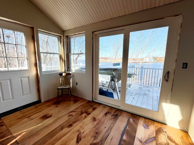 doorway to outside with light wood-type flooring, a water view, vaulted ceiling, and wood ceiling